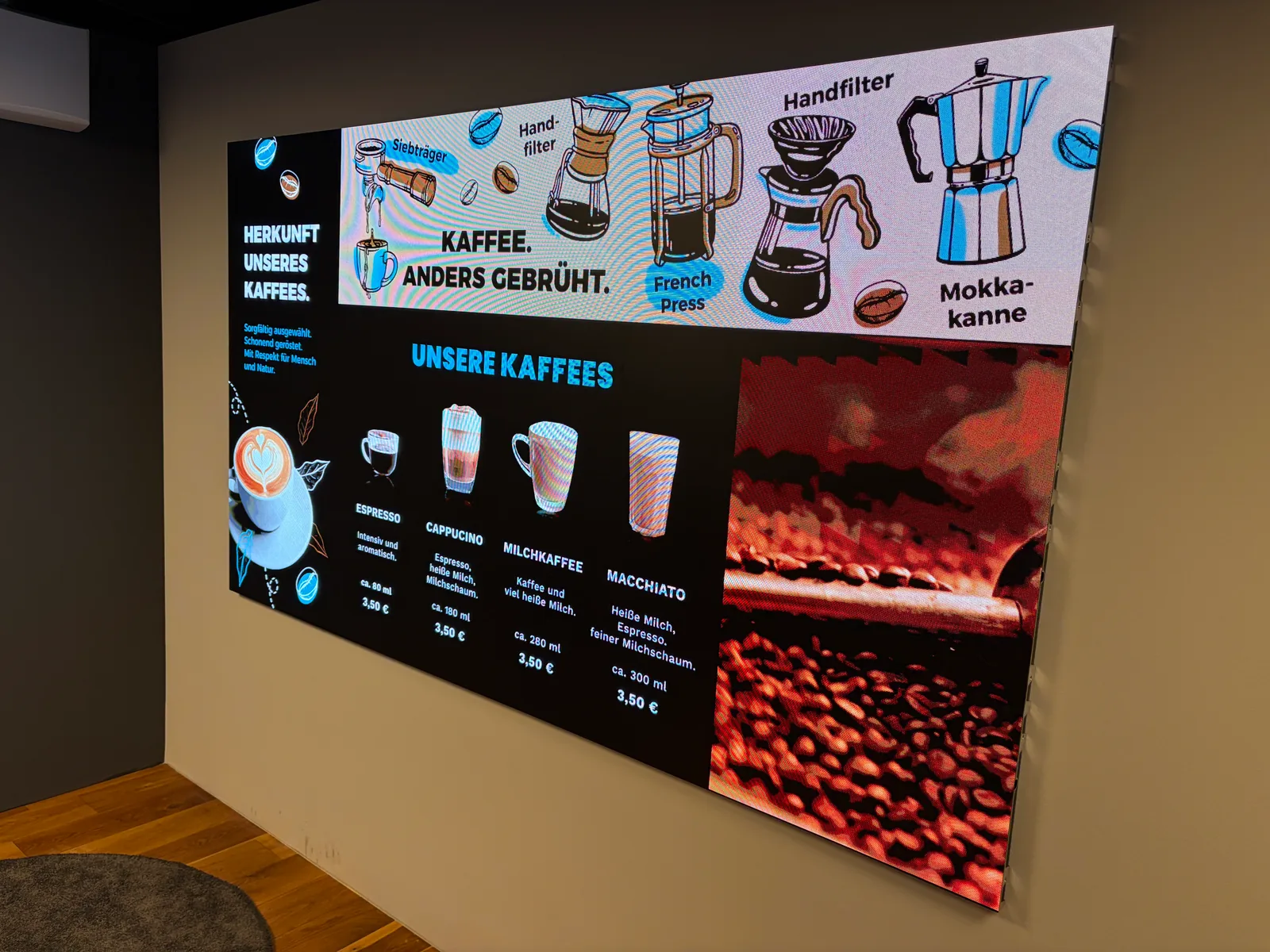 Große LED-Wand im Bütema-Showroom zeigt ein Kaffee-Menü